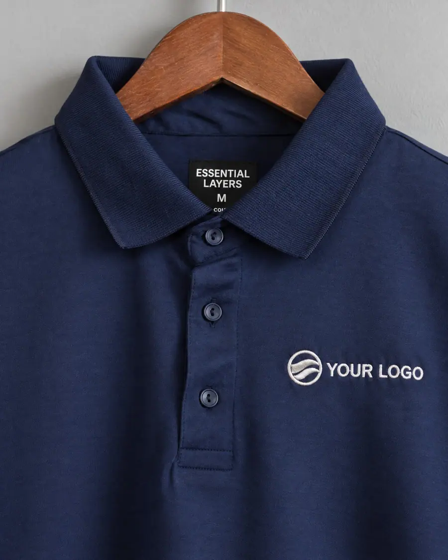 Mock-up of a company logo embroidered in white on the chest of The Signature in Midnight navy